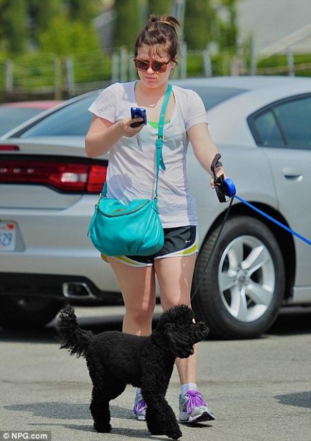 kelly in her gym clothes walking her dogs 